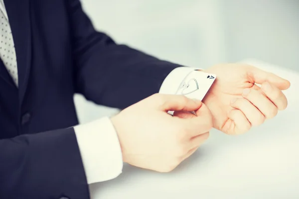 Mans hand hiding ace in the sleeve — Stock Photo, Image