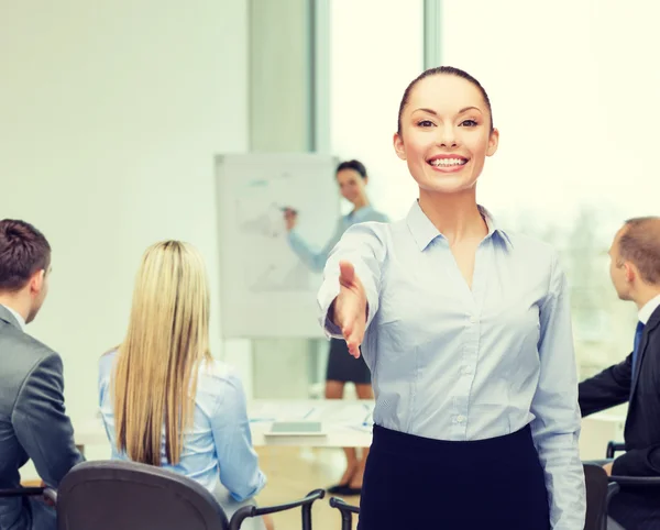 Businesswoman with opened hand ready for handshake — Stock Photo, Image