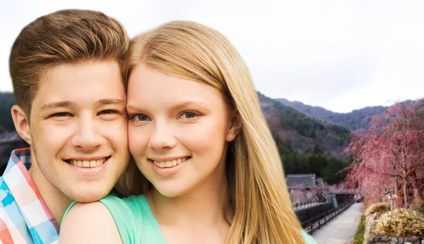 Smiling couple over asian landscape background — Stock Photo, Image