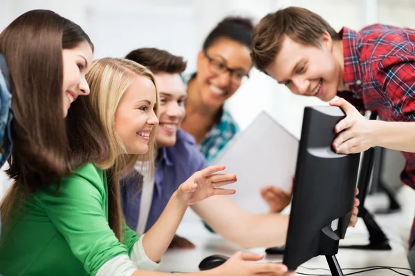 Students looking at computer monitor at school — Stock Photo, Image