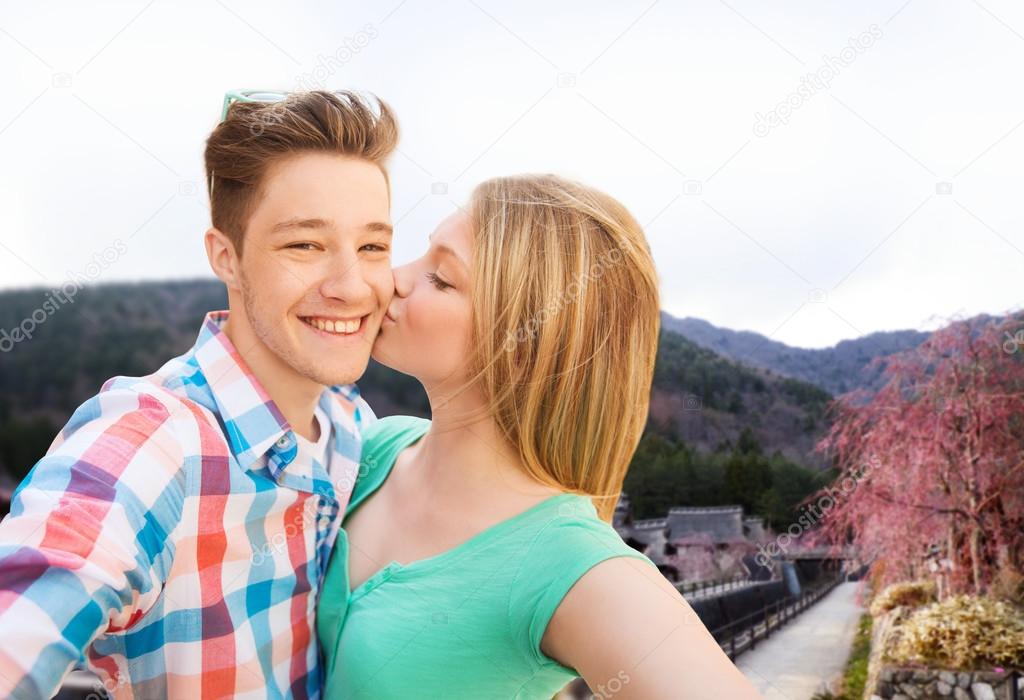 Couple kissing and taking selfie over asian town — Stock Photo © Syda