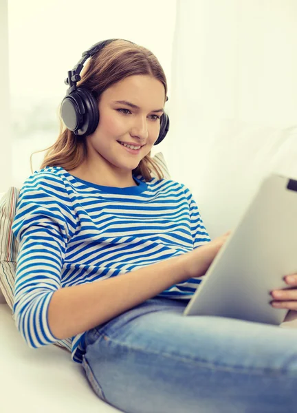 Ragazza con tablet pc e cuffie a casa — Foto Stock