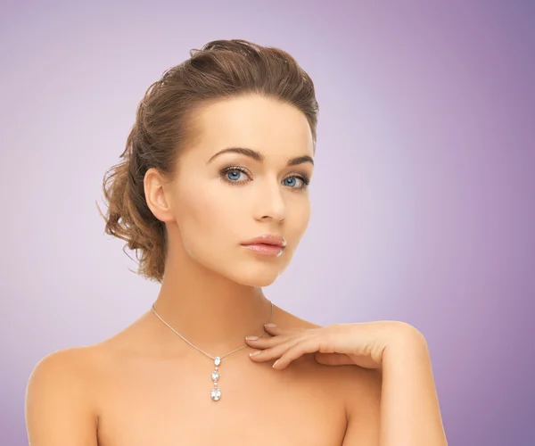 Beautiful young woman with shiny diamond pendant — Stock Photo, Image