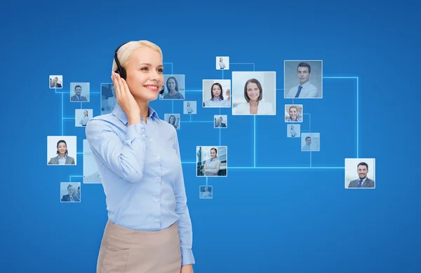 Happy female helpline operator with headphones — Stock Photo, Image