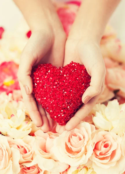 Womans hands holding heart — Stock Photo, Image