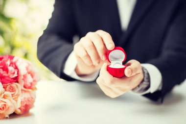 man with gift box and wedding ring clipart