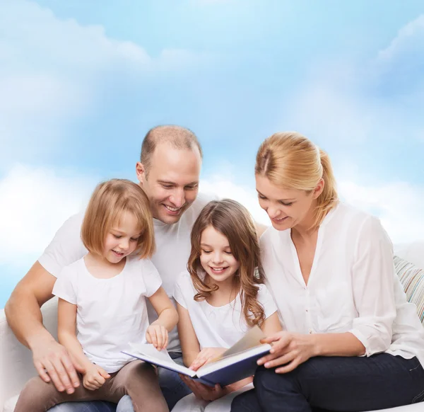 Happy family with book at home — Stock Photo, Image