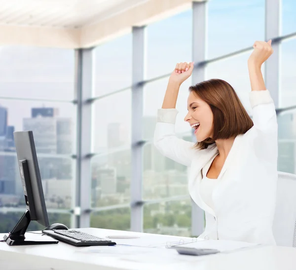 Happy businesswoman with computer in office — Stock Photo, Image