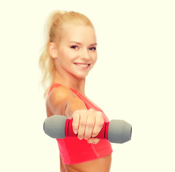 Smiling beautiful sporty woman with dumbbell — Stock Photo, Image