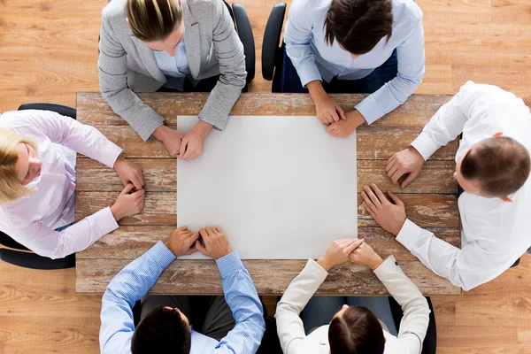 Close up of business team sitting at table — Stock Photo, Image