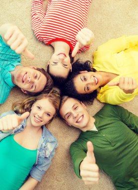group of smiling people lying down on floor clipart
