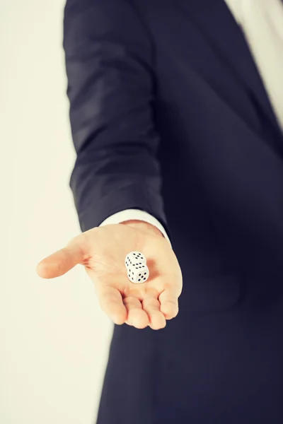 Mans hand holding white casino dice — Stock Photo, Image