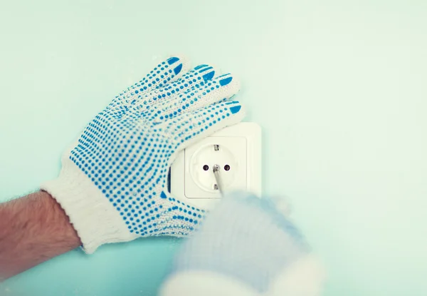 Close up of male in gloves installing new socket — Stock Photo, Image