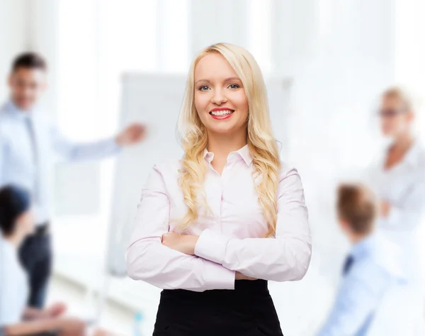 Smiling businesswoman or secretary in office — Stock Photo, Image