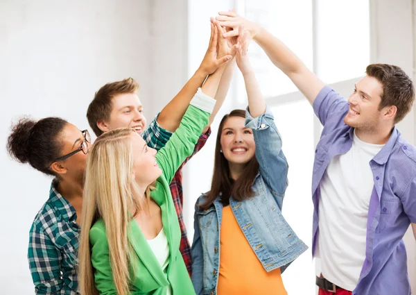 Happy students giving high five at school — Stock Photo, Image