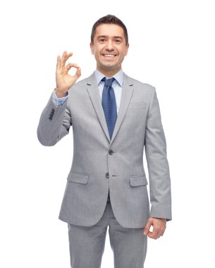 happy businessman in suit showing ok hand sign clipart