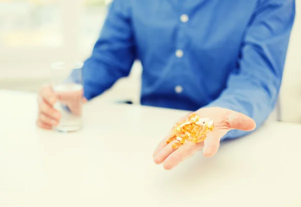 Close up of male hand showing lot of pills — Stock Photo, Image