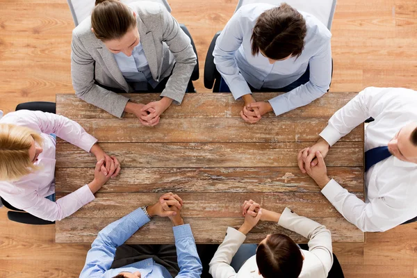 Close up of business team sitting at table — Stock Photo, Image