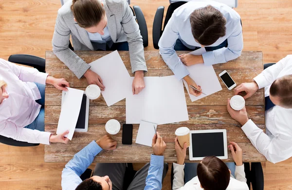 close up of business team with coffee and papers