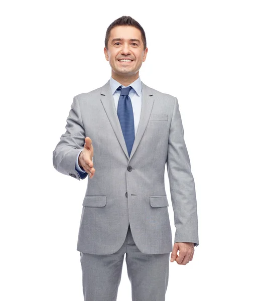 Feliz sonriente hombre de negocios en traje estrechando la mano —  Fotos de Stock