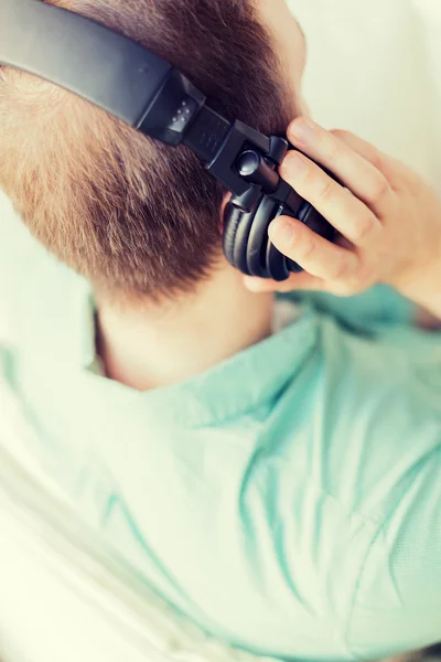 Close up de homem em fones de ouvido em casa — Fotografia de Stock