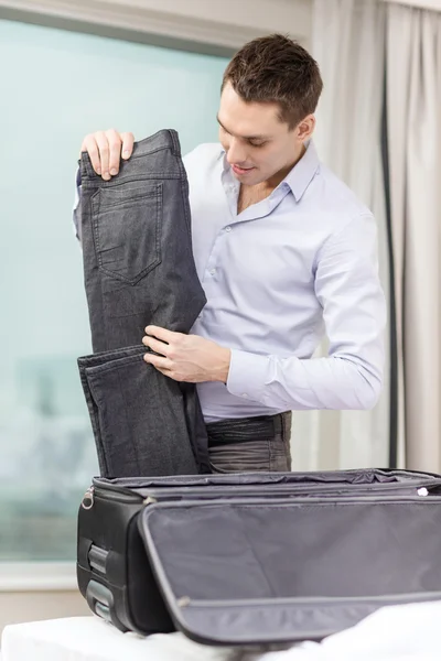 Businessman packing things in suitcase — Stock Photo, Image