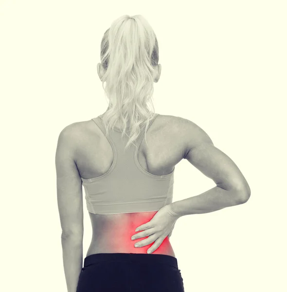 Sporty woman touching her back — Stock Photo, Image