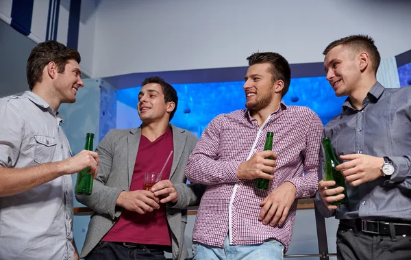 group of male friends with beer in nightclub