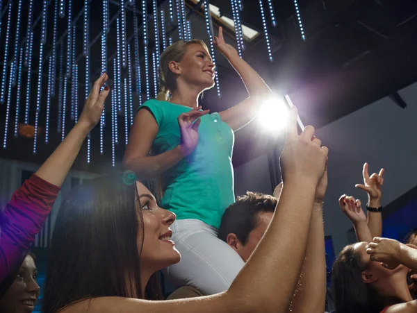 Friends with smartphone taking picture at concert — Stock Photo, Image