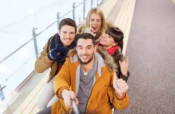 Happy friends taking selfie on skating rink — Stock Photo, Image