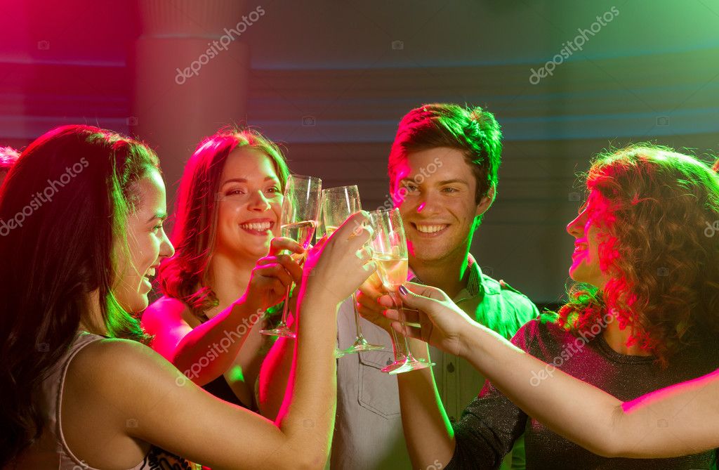 party, technology, nightlife and people concept - smiling friends with  smartphone taking selfie in club. Stock Photo