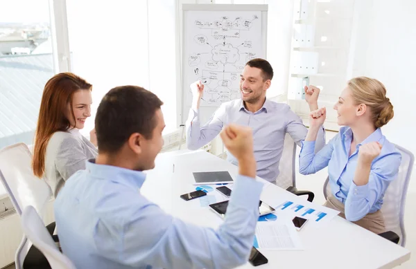 Smiling business people meeting in office Stock Image