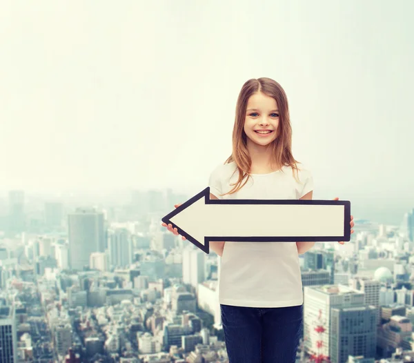 Smiling girl with blank arrow pointing left — Stock Photo, Image