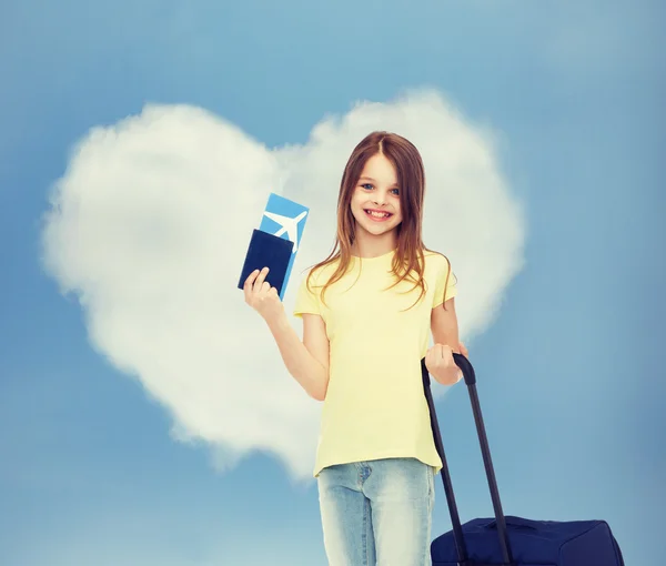 Menina sorridente com bilhete de viagem saco e passaporte — Fotografia de Stock