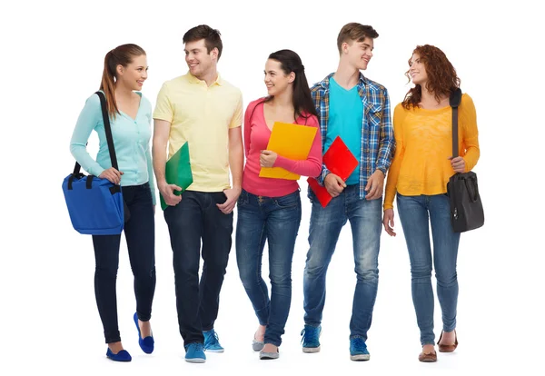 Grupp leende tonåringar med mappar och väskor — Stockfoto