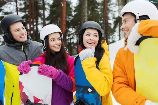 Heureux amis dans les casques avec snowboards parler — Photo