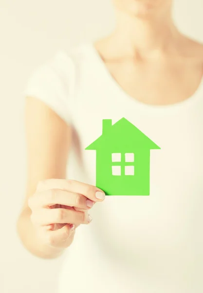 Woman hands holding green house — Stock Photo, Image