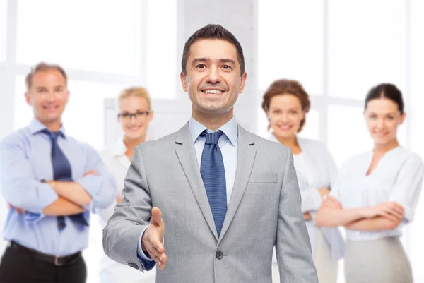 Happy smiling businessman in suit shaking hand — Stock Photo, Image