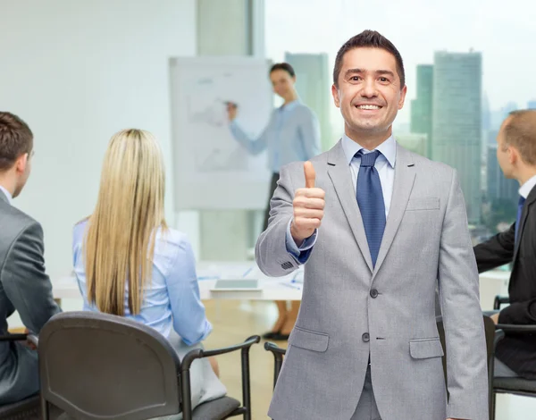 Happy businessman in suit showing thumbs up — Stock Photo, Image