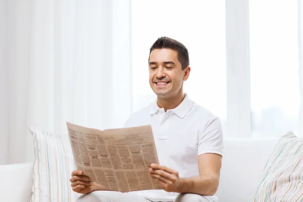 Happy man reading newspaper at home — Stock Photo, Image