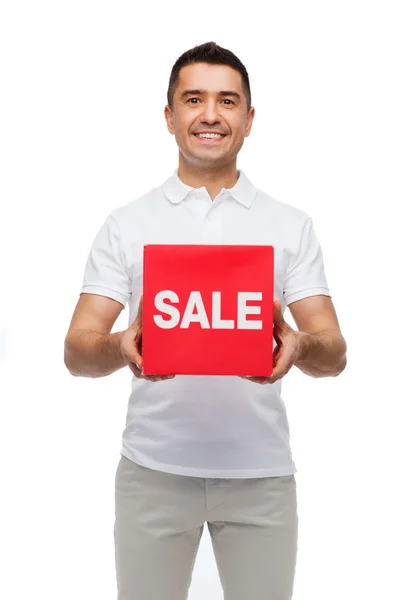 Sonriente hombre con rojo venta suspiro — Foto de Stock