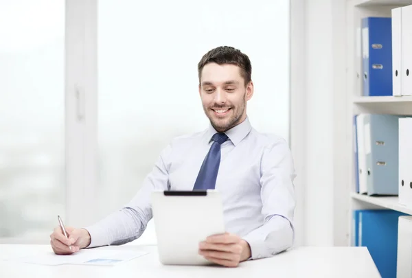 Smiling businessman with tablet pc and documents — Stock Photo, Image