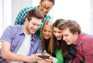 students looking at smartphone at school clipart