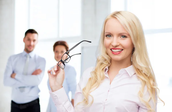 Smiling businesswoman or secretary in office — Stock Photo, Image