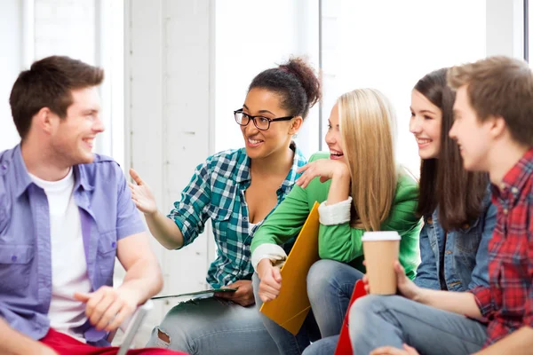 Students communicating and laughing at school — Stock Photo, Image