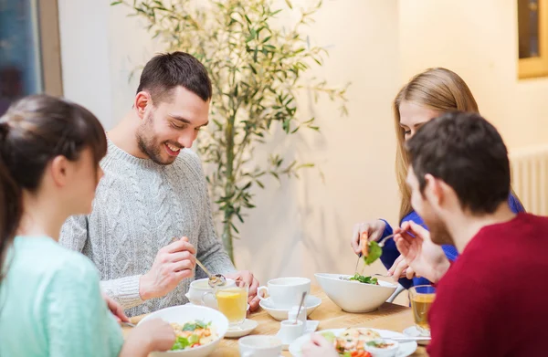 Happy friends meeting and having dinner at cafe — Stock Photo, Image