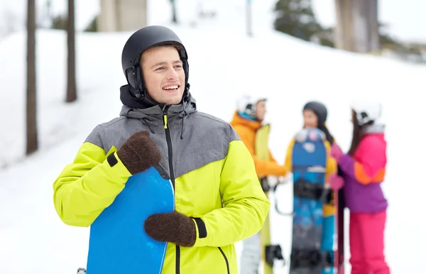 Šťastní přátelé v helmách se snowboardy — Stock fotografie