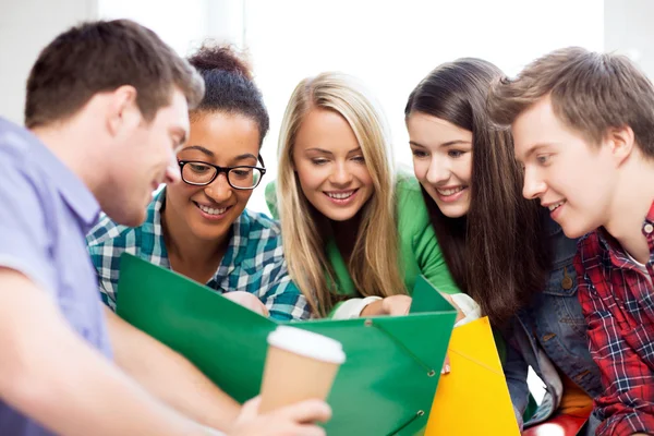 Students looking at notebook at school — Stock Photo, Image