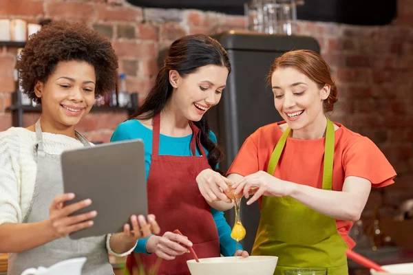 happy women with tablet pc in kitchen