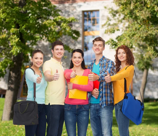 Group of smiling teenagers showing thumbs up Royalty Free Stock Photos